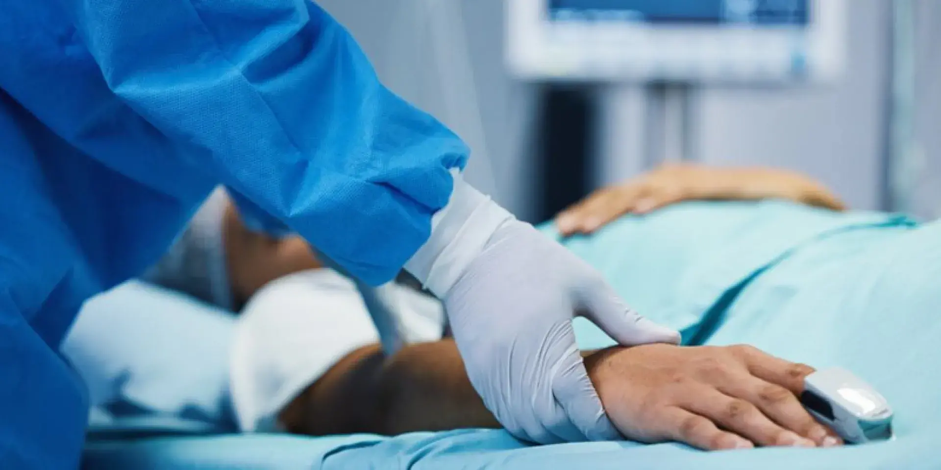 Medical professional checking pulse of hospital patient