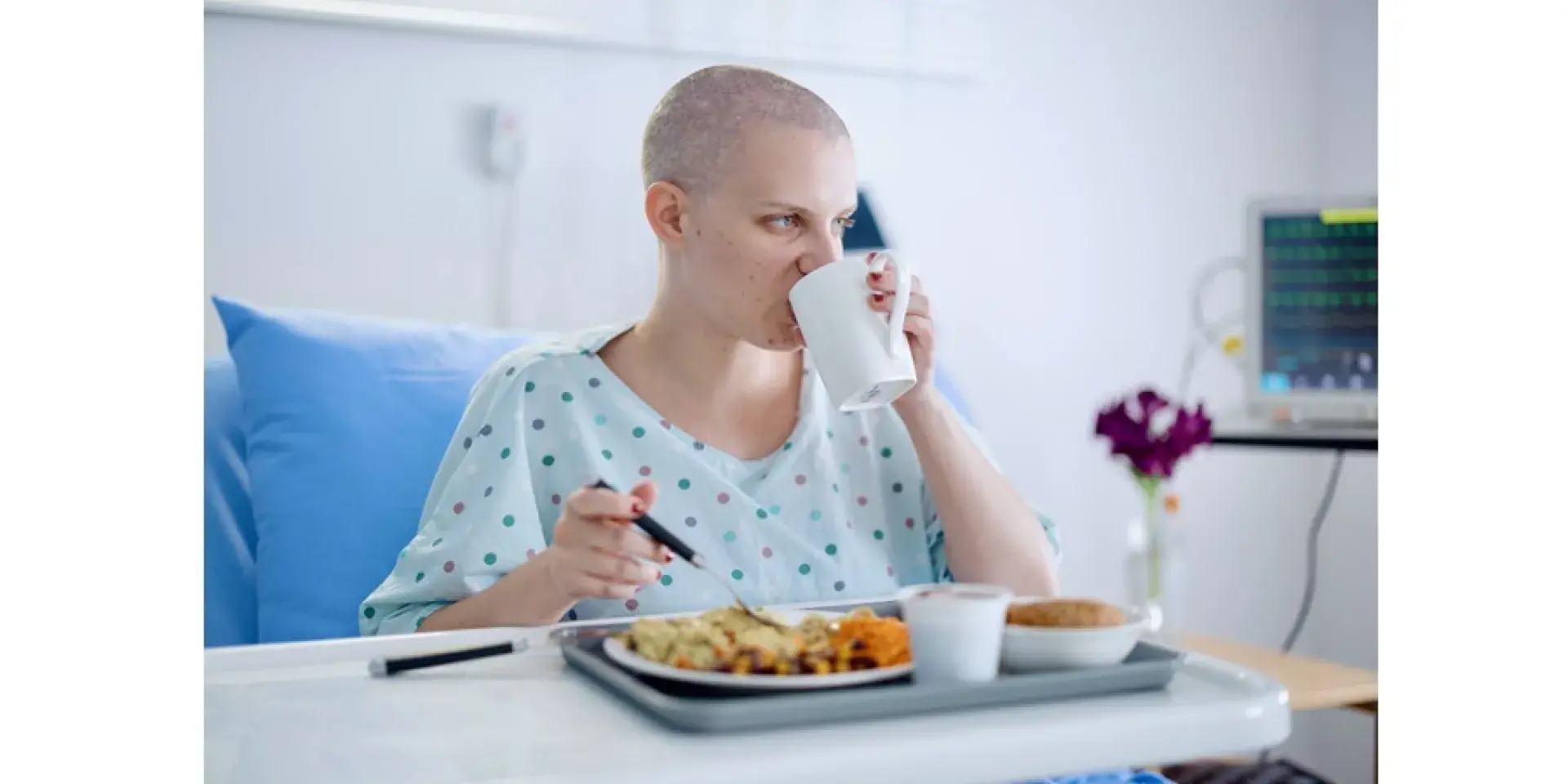 Cancer patient in hospital drinking and eating