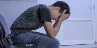 Young man with head in his hands