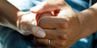 pair of hands holding each other