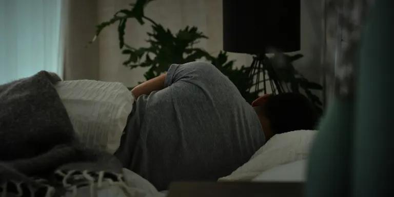 person lying in a bed