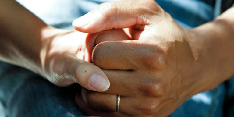 pair of hands holding each other