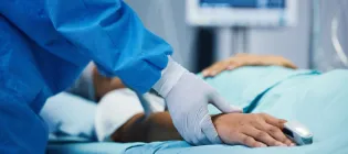Medical professional checking pulse of hospital patient