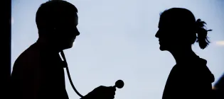 Silhouette of doctor talking to a patient