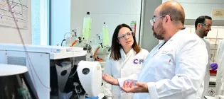 Katie Forbes talking to Asier Unciti-Broceta in a lab
