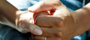 close up of two hands holding each other