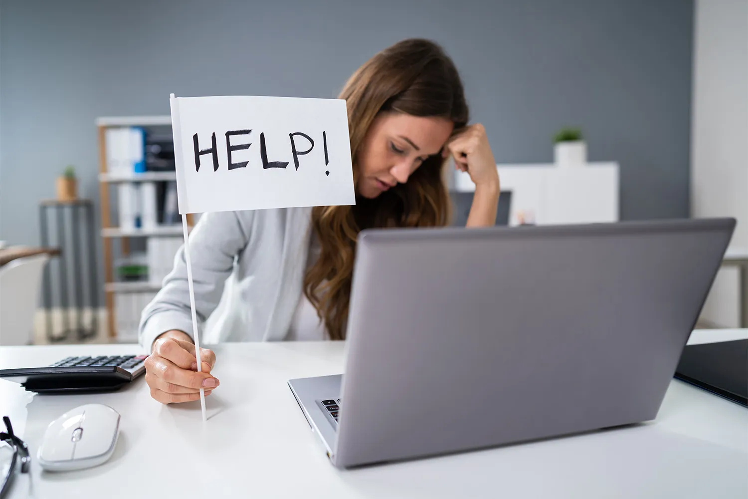 Woman at desk needing help