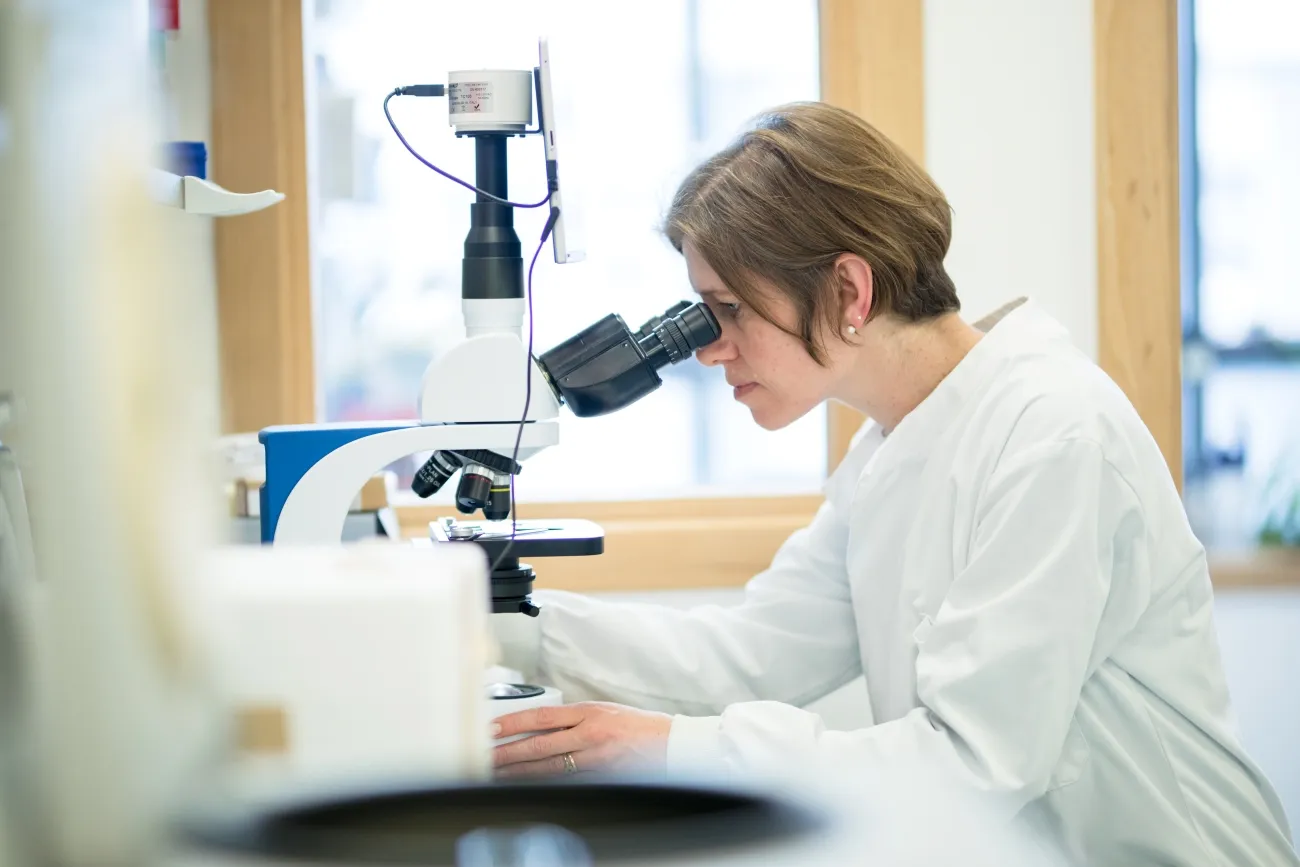 Professor Sara Brown at a microscope