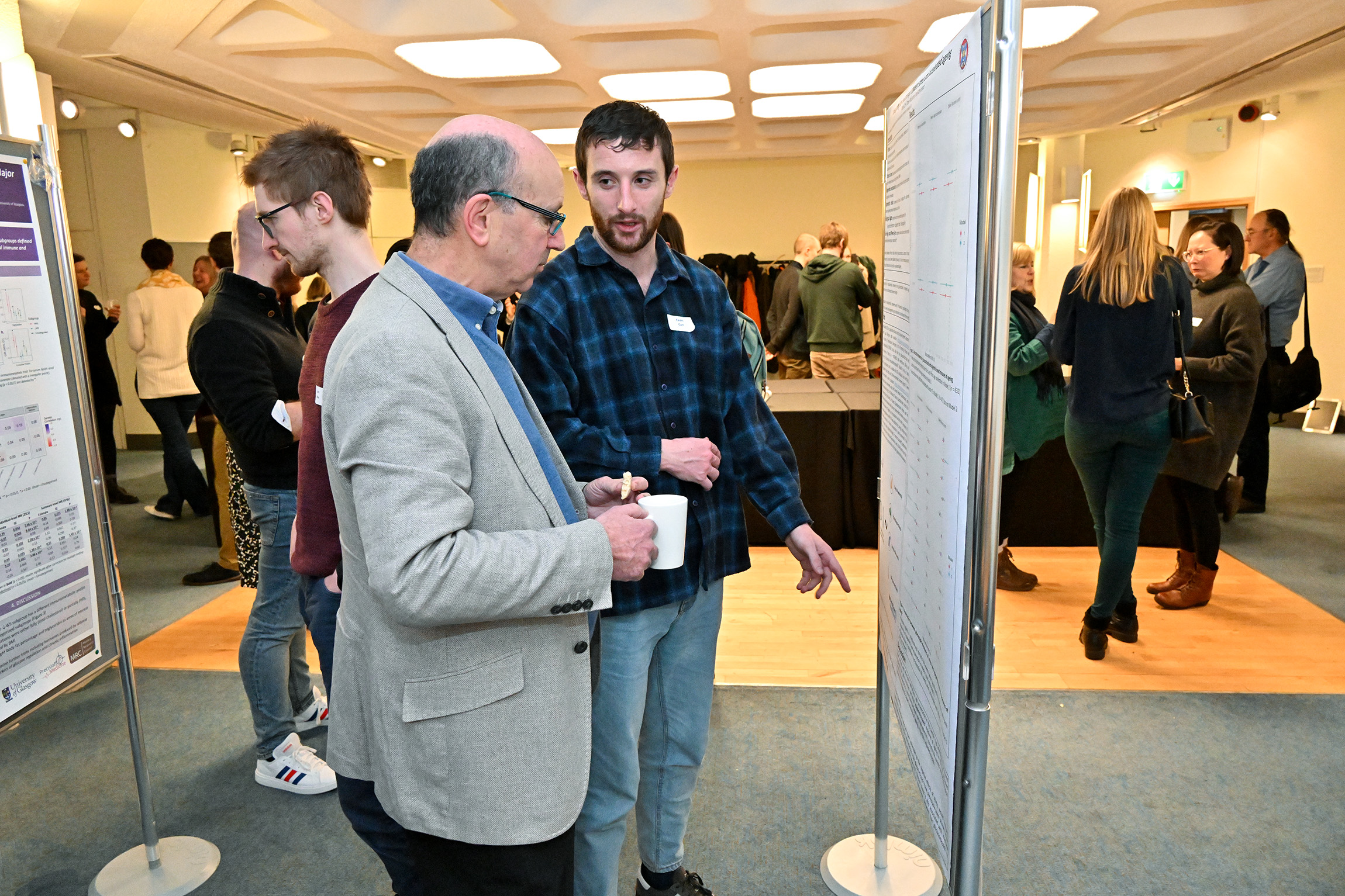 Kevin Carr discussing his flash talk poster to the director of CGEM