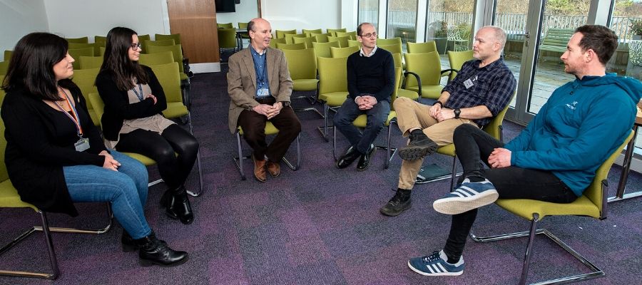 Simon talks with a group of researchers